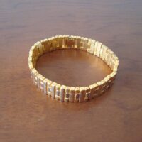 Golden jewelry bracelet with silver hooks
